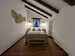 a bedroom with a bed in a room with a window at Molino Angorrilla in Cádiz