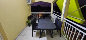 a balcony with a table and chairs on a balcony at Dyna condo one in Sainte-Rose