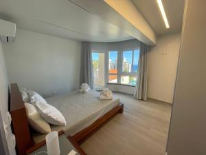 a bedroom with a bed and a large window at Luxurious T2 Varandas Apartment XIII in Funchal +18 photos