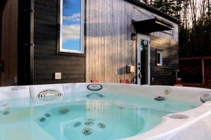 a large bath tub in front of a house at Chalets BSL in Saint-Simon-de-Rimouski