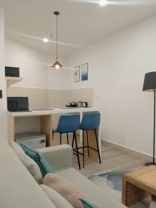 a living room with a couch and a kitchen at The Shore Seaview A1817 in Kota Kinabalu