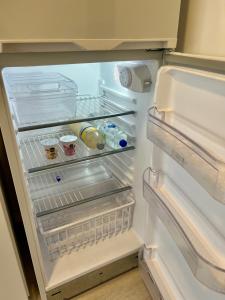 a refrigerator with its door open with food inside at Arevalito Monoambiente in Buenos Aires