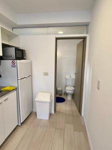 a small kitchen with a refrigerator and a toilet at Arevalito Monoambiente in Buenos Aires +14 photos