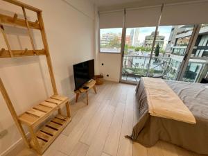 a bedroom with a bunk bed and a television at Arevalito Monoambiente in Buenos Aires