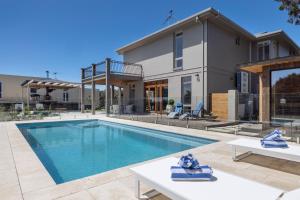 a house with a swimming pool in front of a house at Serendib Luxury Sorrento Resort Living in Sorrento