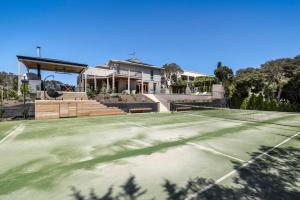 a tennis court in front of a house at Serendib Luxury Sorrento Resort Living in Sorrento