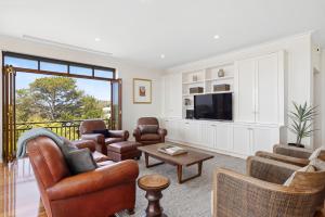 a living room with a couch and chairs and a tv at Serendib Luxury Sorrento Resort Living in Sorrento