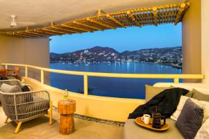 a balcony with a view of the water at Villas Kaukan by Tasman in Zihuatanejo