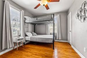 a bedroom with a bed and a ceiling fan at East Hill Retreat Near Beaches & Downtown in Pensacola