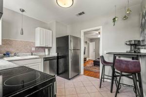 a kitchen with a stainless steel refrigerator and a counter at East Hill Retreat Near Beaches & Downtown in Pensacola