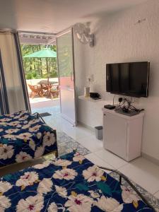 a bedroom with a bed and a flat screen tv at Terrace Forest View Suites in Yelagiri