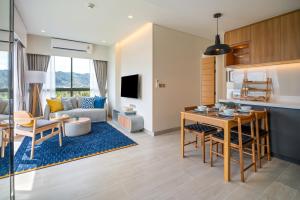 a kitchen and a living room with a table at Laguna Lakeside Residences by Banyan Living in Bang Tao Beach