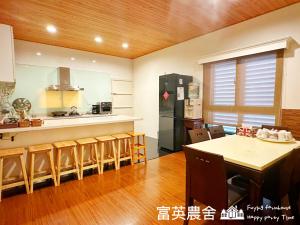 a kitchen with a dining table and a refrigerator at Fuying Farmhouse in Dongshan