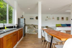 a kitchen with a wooden table and a dining room at 4 bed rooms sea view villa with pool in Chaloklum