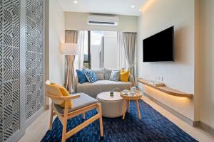a living room with a couch and a tv at Laguna Lakeside Residences by Banyan Living in Bang Tao Beach +29 photos