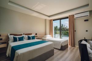 Postel nebo postele na pokoji v ubytování Ocean Pearl Fuvahmulah