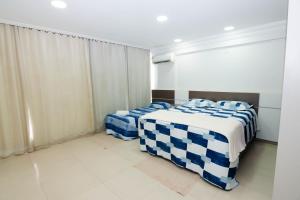 Ένα ή περισσότερα κρεβάτια σε δωμάτιο στο Manaus Sension 507