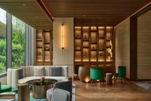 a lobby with a couch and chairs and a table at InterContinental Taichung by IHG in Taichung