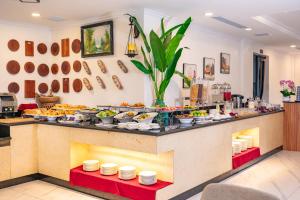 a buffet with a lot of food on a counter at Athenia Hoi An Boutique Hotel & Spa in Hoi An
