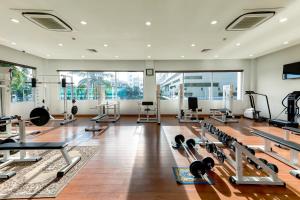 a gym with a lot of treadmills and machines at Sunflower International Village in Hai Phong