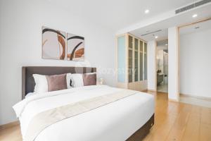a white bedroom with a large white bed at Nieve by Kozystay - Cilandak in Jakarta +30 photos
