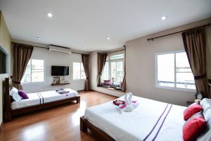 a large room with two beds and a television at CC Villa House Chiangmai in Ban Mae Hom +23 photos