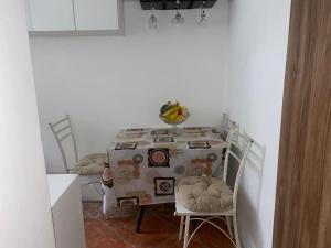 a room with a table and two chairs and a table with at Suite De Ana in Guayaquil