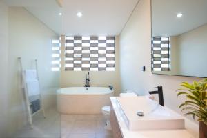a bathroom with a tub and a toilet and a sink at Villa Biku in Umalas +15 photos