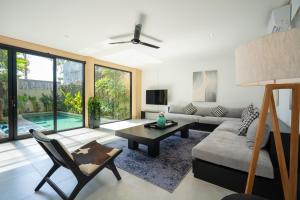 a living room with a couch and a table at Villa Biku in Umalas