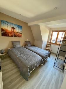 a bedroom with a bed and a large window at Maison de charme - 7 personnes - centre ville in Obernai
