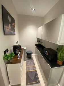a kitchen with a sink and a toilet at إستديو هادئ حي حطين قريب من البوليفارد in Riyadh
