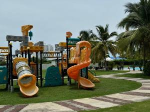 a playground in a park with a slide and slides at Alojamiento Vacacional de Playa in Río Hato