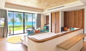 a bedroom with a large bed with a view of the ocean at TTC Van Phong Bay Resort - Himalaya Sauna & Steam Retreat Included in Ninh Hòa