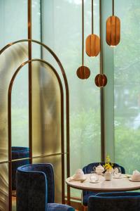 a dining room with a table and blue chairs at InterContinental Taichung by IHG in Taichung