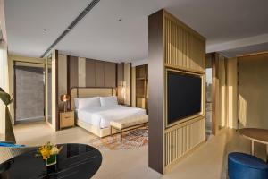 a hotel room with a bed and a tv at InterContinental Taichung by IHG in Taichung