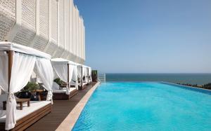 a swimming pool on the side of a hotel at The Westin Sanya Haitang Bay Resort in Sanya +248 photos
