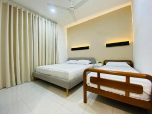 Giường trong phòng chung tại Alyn Home Kluang VI Netflix Coway