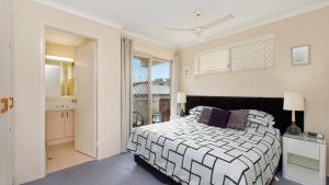 a bedroom with a bed and a balcony at Kookaburra Court Unit 6 in Golden Beach