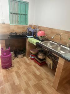 a kitchen with a sink and a counter with pots and pans at Home Sun Moon - Phòng Đôi in Phan Thiet