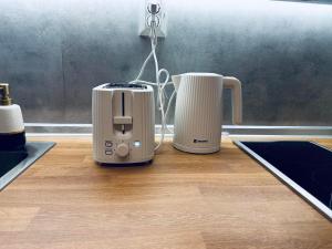 a toaster and a toaster sitting on a kitchen counter at Sky Hills 2 Apartment in Sandanski