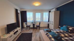 a bedroom with a bed and a table with chairs at Lavender Lodge Tsarichino in Tsarichino