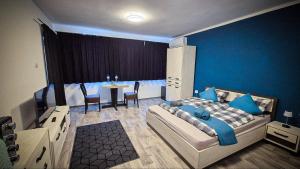 a bedroom with a bed and a table with chairs at Lavender Lodge Tsarichino in Tsarichino