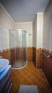 a bathroom with a shower and a sink at Lavender Lodge Tsarichino in Tsarichino +19 photos