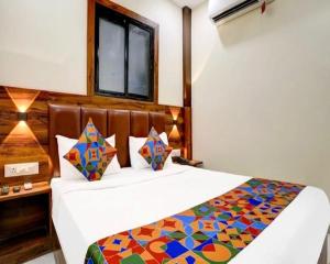 a bedroom with a bed and a window at Hotel Golden Sands Inn Aslpha in Mumbai
