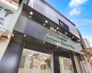 a sign on the side of a store at Hotel Golden Sands Inn Aslpha in Mumbai
