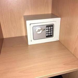 a white microwave sitting on a wooden shelf at San Pio Bed & Breakfast in Cariati