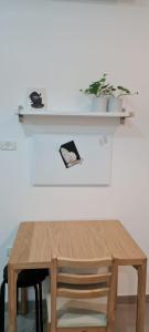 a wooden table with a chair and a shelf at Desert Shine in Qiryat Gat