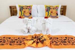 a bed with towels and stuffed animals on it at PMS Boutique Patong in Patong Beach