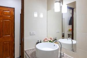a bathroom with a sink and a mirror at PMS Boutique Patong in Patong Beach