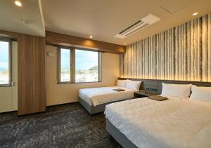 Postel nebo postele na pokoji v ubytování Hotel and Spa Gift TAKAYAMA